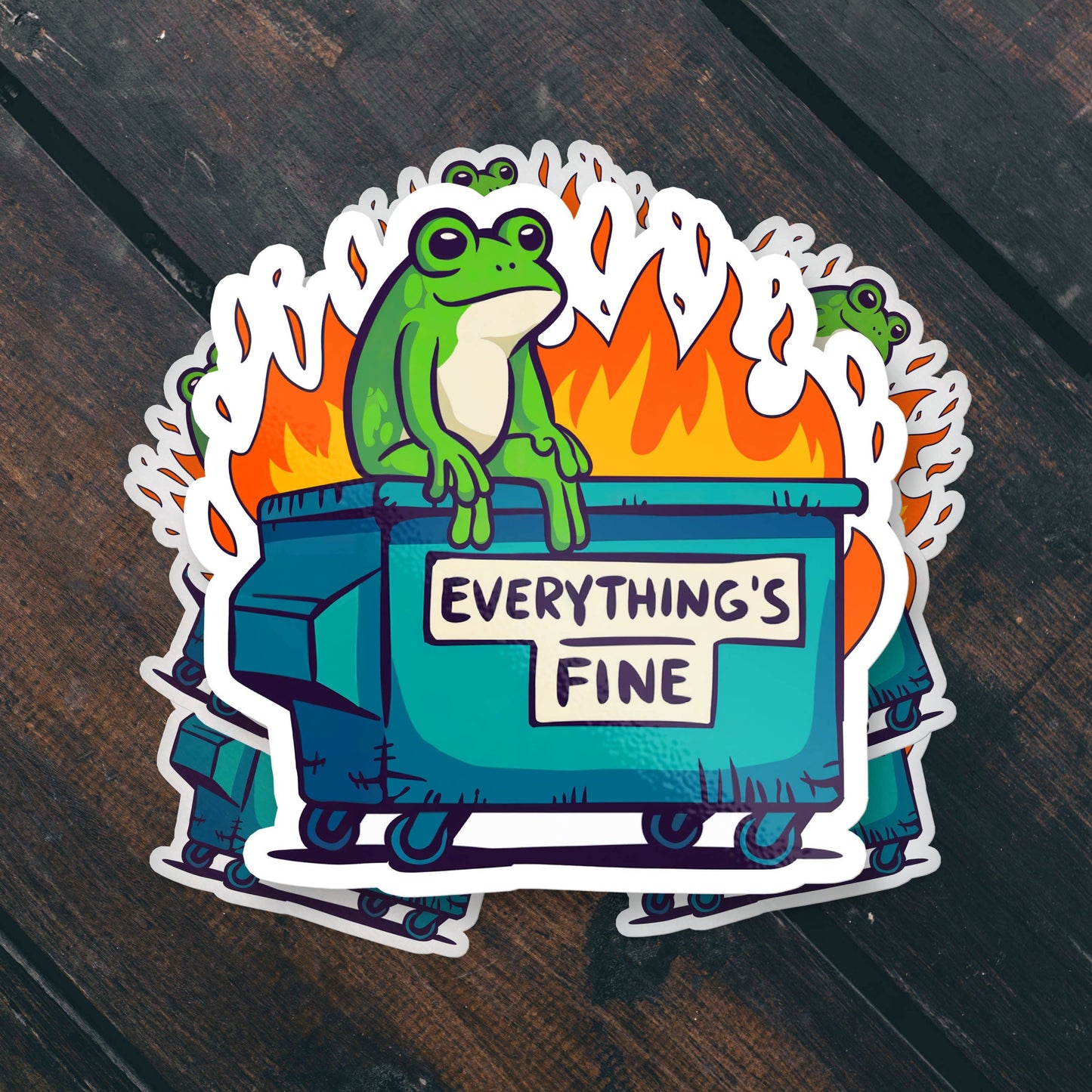 Sticker with a frog on a dumpster labeled 'Everything's Fine' against a fiery background.