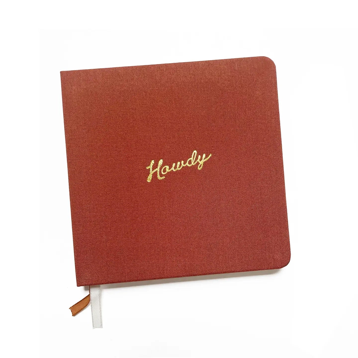 rust colored notebook with 'Howdy' embroidery on a white background