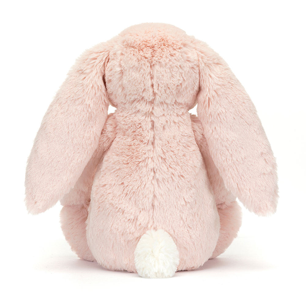 Back side of a pink plush bunny on a white background