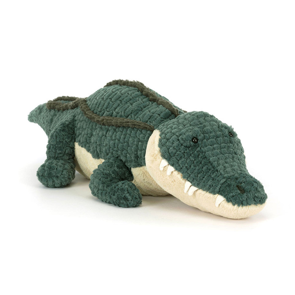 Plush toy alligator on a white background