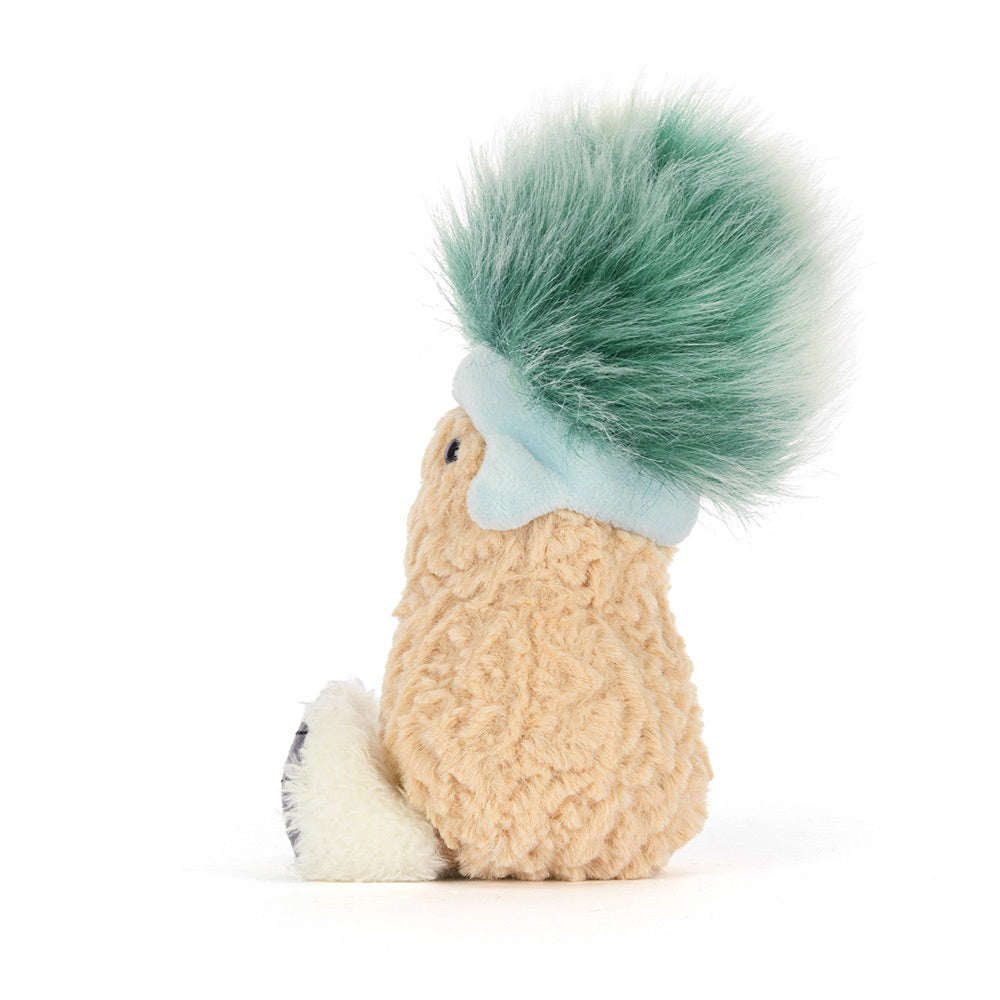 Plush toy peanut with a green tuft of hair on a white background