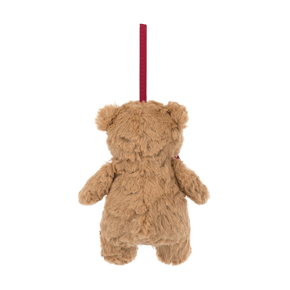 Brown teddy bear ornament hanging from a red ribbon on a white background