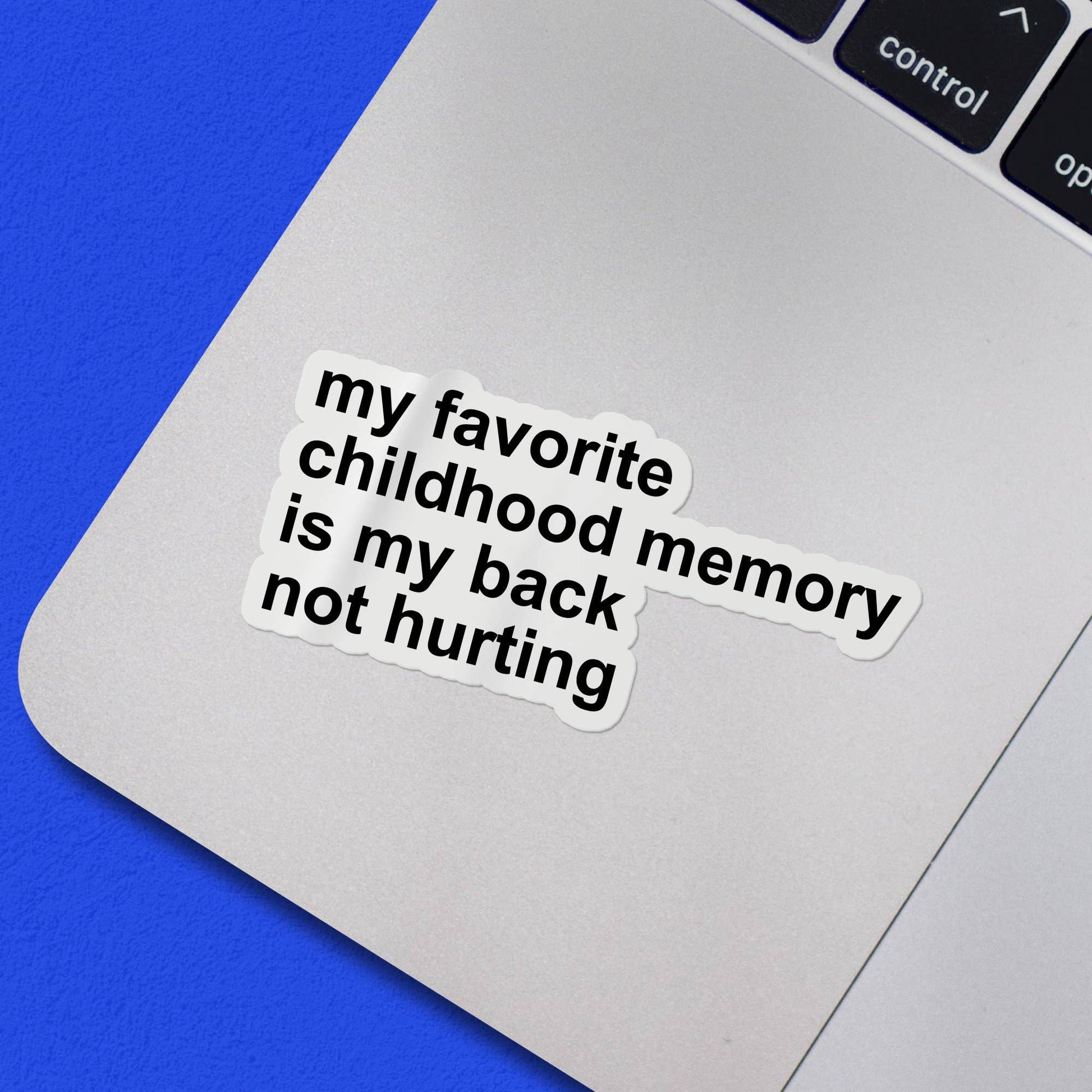 Laptop with a sticker reading 'my favorite childhood memory is my back not hurting' on a blue background