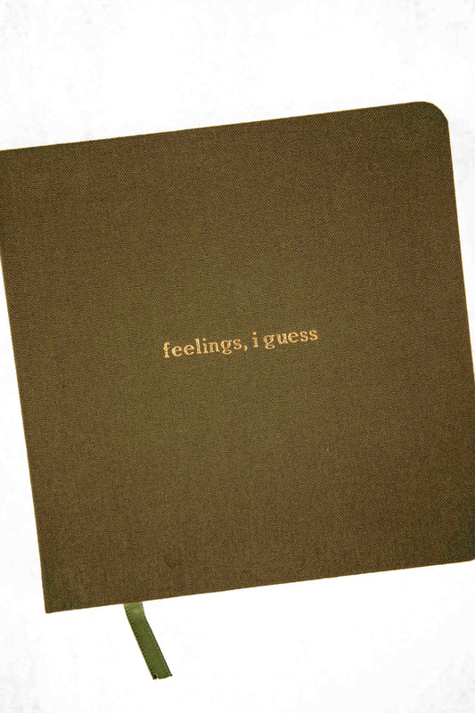 olive colored  notebook with 'feelings, i guess' text embossed on a white background