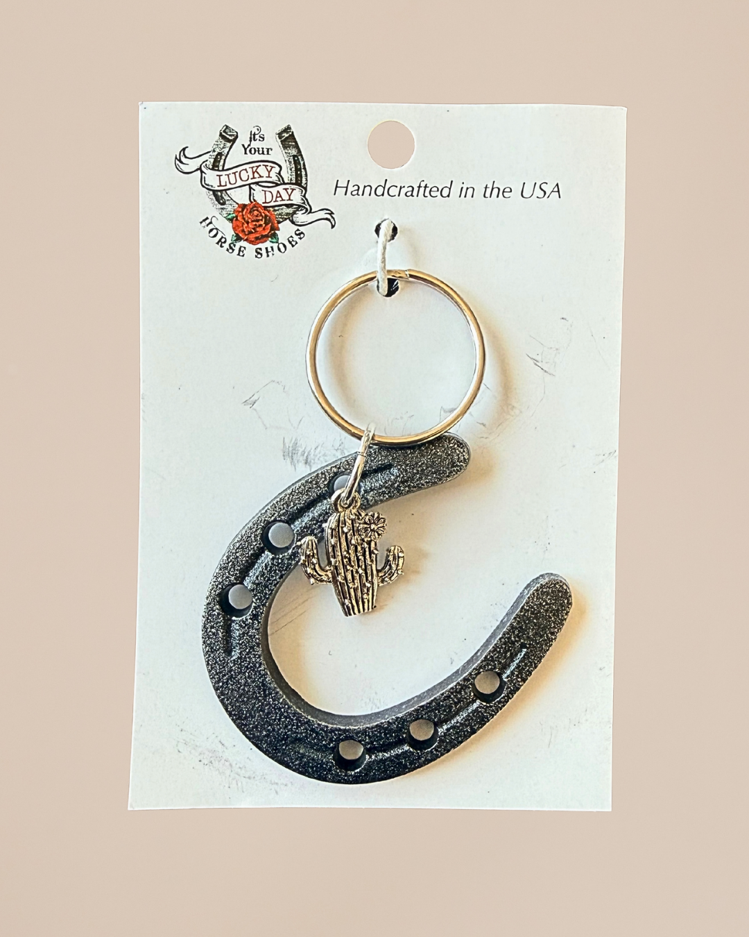 Horseshoe keychain with cactus charm on a Lucky Day USA card